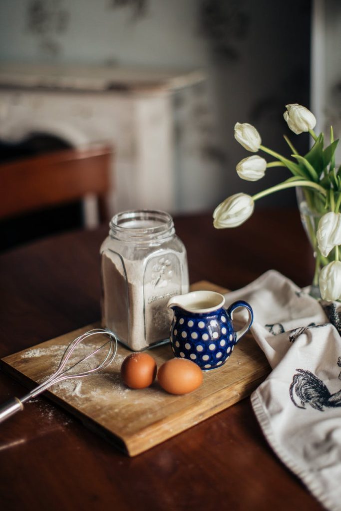 ingredients for dough and flowers on table